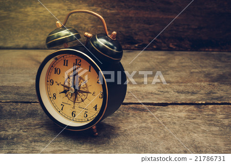 Still life with alarm clock on wood table. Still life with alarm clock on wood table. 21786731