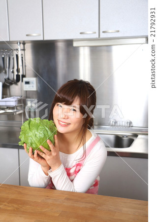 A woman with lettuce in the kitchen 21792931