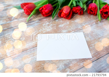 close up of red tulips and blank paper or letter close up of red tulips and blank paper or letter 21793794