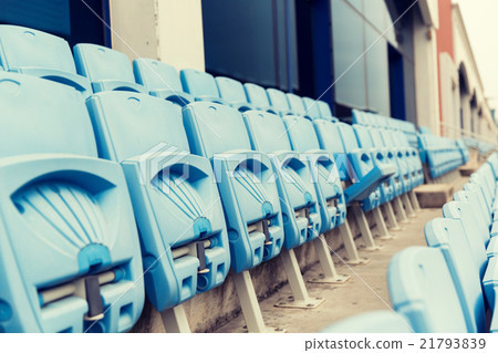 rows with folded seats of bleachers on stadium 21793839