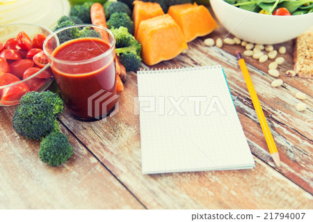 close up of ripe vegetables and notebook on table close up of ripe vegetables and notebook on table 21794007
