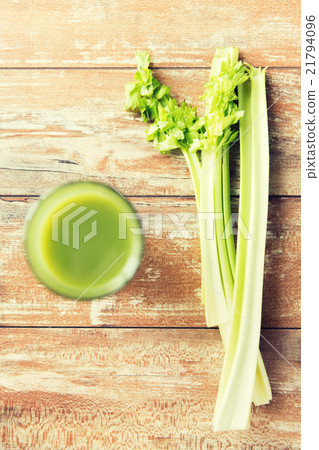 close up of fresh green juice glass and celery close up of fresh green juice glass and celery 21794096