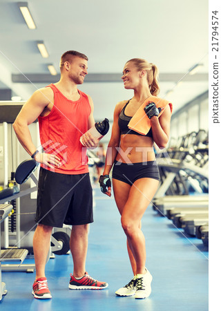 smiling man and woman talking in gym 21794574