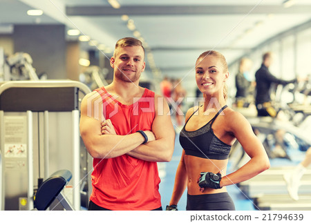 smiling man and woman in gym 21794639
