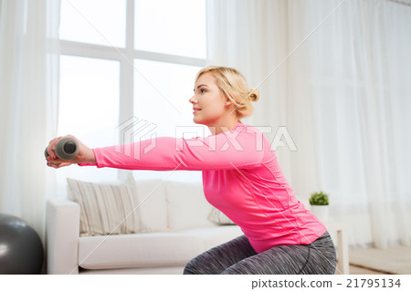 smiling woman with dumbbells exercising at home smiling woman with dumbbells exercising at home 21795134