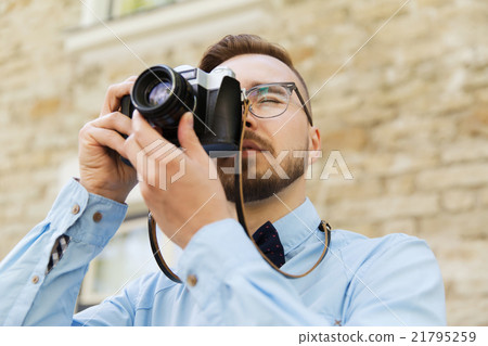 young hipster man with film camera in city young hipster man with film camera in city 21795259