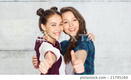 happy smiling teenage girls showing thumbs up happy smiling teenage girls showing thumbs up 21795260