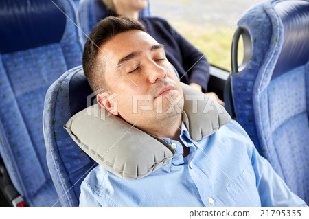 man sleeping in travel bus with cervical pillow 21795355