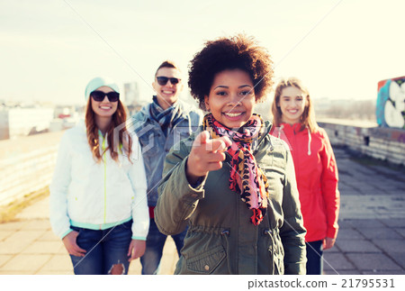 happy friends pointing finger to you on street 21795531