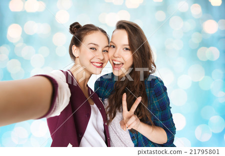 happy friends taking selfie and showing peace happy friends taking selfie and showing peace 21795801