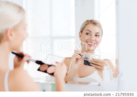 woman with makeup brush and foundation at bathroom woman with makeup brush and foundation at bathroom 21795930