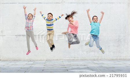 happy little girl jumping in air on street happy little girl jumping in air on street 21795931