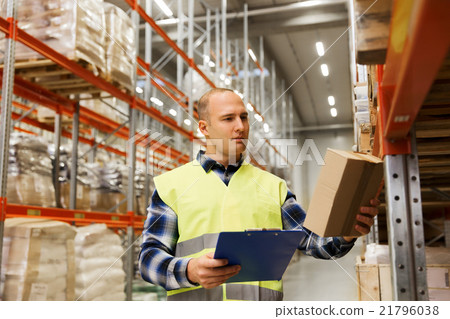 man with clipboard in safety vest at warehouse 21796038