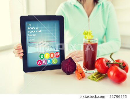 close up of woman with tablet pc and vegetables close up of woman with tablet pc and vegetables 21796355
