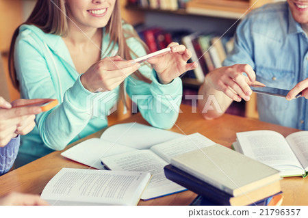 students with smartphones making cheat sheets students with smartphones making cheat sheets 21796357