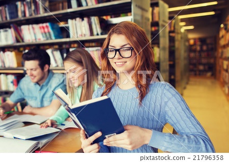 happy students reading books in library happy students reading books in library 21796358