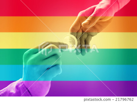 close up of male gay couple hands giving condom close up of male gay couple hands giving condom 21796762