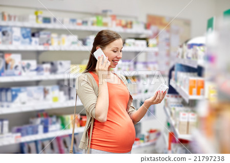happy pregnant woman with smartphone at pharmacy happy pregnant woman with smartphone at pharmacy 21797238