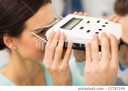 optician with pupillometer and patient at eye clinic optician with pupillometer and patient at eye clinic 21797249