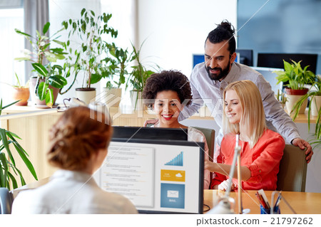 happy creative team with computer in office happy creative team with computer in office 21797262