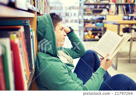 student boy or young man reading book in library student boy or young man reading book in library 21797264