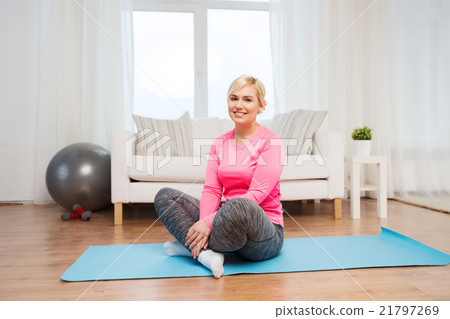 happy woman sitting on mat at home happy woman sitting on mat at home 21797269