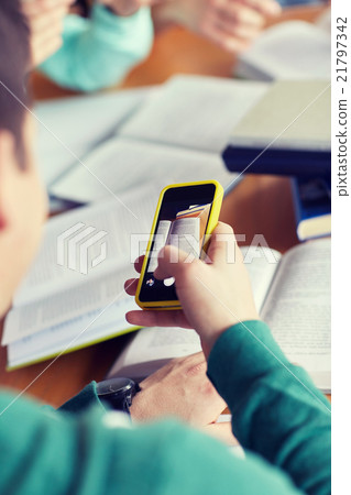 student hands with smartphone making cheat sheet student hands with smartphone making cheat sheet 21797342