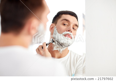 man shaving beard with razor blade at bathroom man shaving beard with razor blade at bathroom 21797602