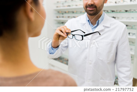 close up of optician with glasses at optics store close up of optician with glasses at optics store 21797752
