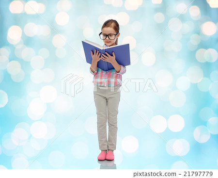 happy little girl in eyeglasses reading book 21797779