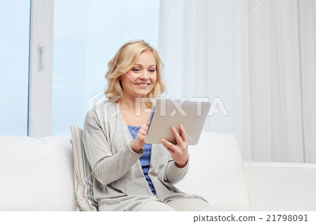 happy middle aged woman with tablet pc at home happy middle aged woman with tablet pc at home 21798091