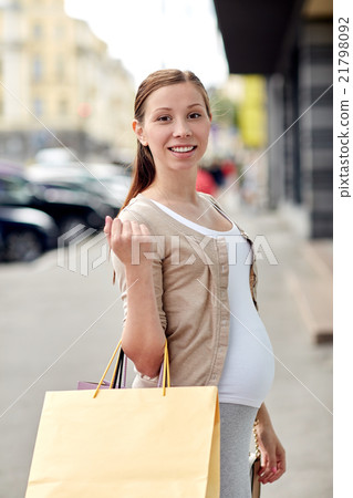 happy pregnant woman with shopping bags at city happy pregnant woman with shopping bags at city 21798092