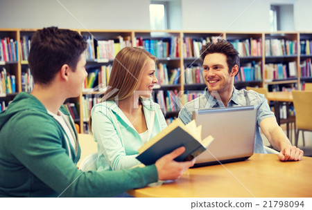 happy students with laptop and books at library happy students with laptop and books at library 21798094