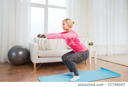 smiling woman with dumbbells exercising at home smiling woman with dumbbells exercising at home 21798097