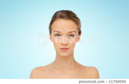 young woman face with bare shoulders over blue young woman face with bare shoulders over blue 21798099
