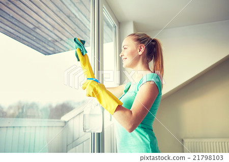 happy woman in gloves cleaning window with rag happy woman in gloves cleaning window with rag 21798103