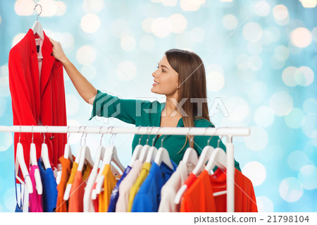 happy woman choosing clothes at wardrobe happy woman choosing clothes at wardrobe 21798104