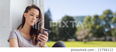 sad pretty teenage girl with smartphone texting sad pretty teenage girl with smartphone texting 21798112