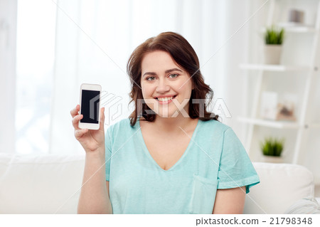happy plus size woman with smartphone at home happy plus size woman with smartphone at home 21798348