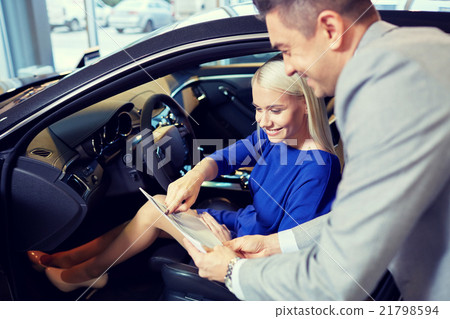 happy woman with car dealer in auto show or salon 21798594