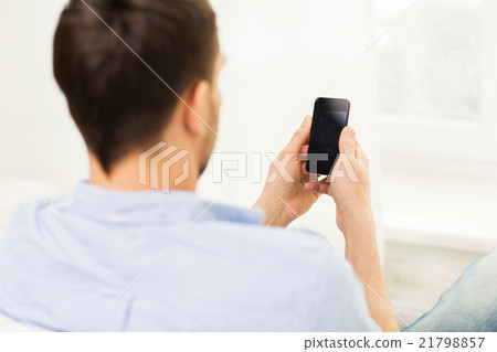 close up of man with smartphone at home 21798857