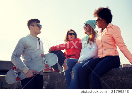 happy teenage friends with skateboard on street happy teenage friends with skateboard on street 21799248