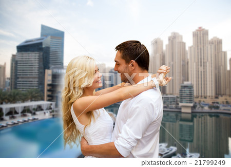 happy couple hugging over dubai city background happy couple hugging over dubai city background 21799249