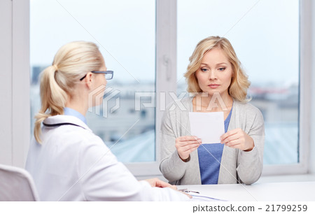 doctor giving prescription to woman at hospital doctor giving prescription to woman at hospital 21799259