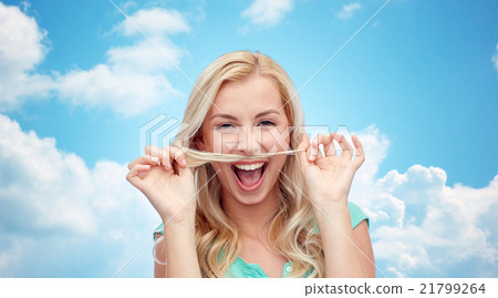 happy young woman making mustache with her hair 21799264
