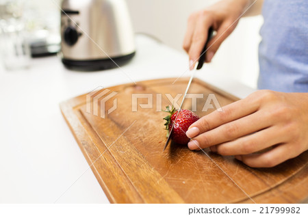close up of woman chopping strawberry at home close up of woman chopping strawberry at home 21799982