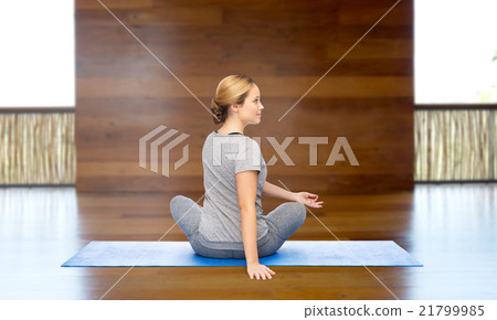 woman making yoga in twist pose on mat woman making yoga in twist pose on mat 21799985