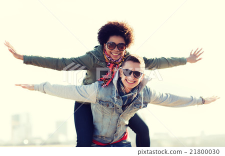 happy teenage couple in shades having fun outdoors 21800030