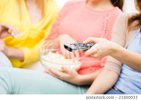 close up of teenage girls with remote watching tv close up of teenage girls with remote watching tv 21800033