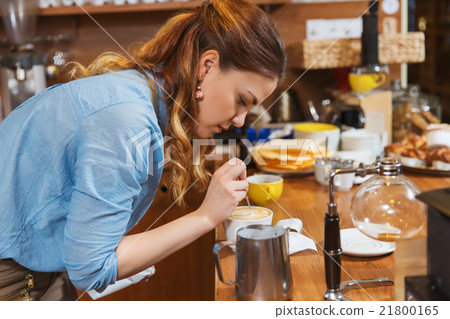 barista woman making latte art at coffee shop barista woman making latte art at coffee shop 21800165